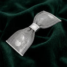 Silver Tone Mesh Bow Hair Barrette on dark green fabric