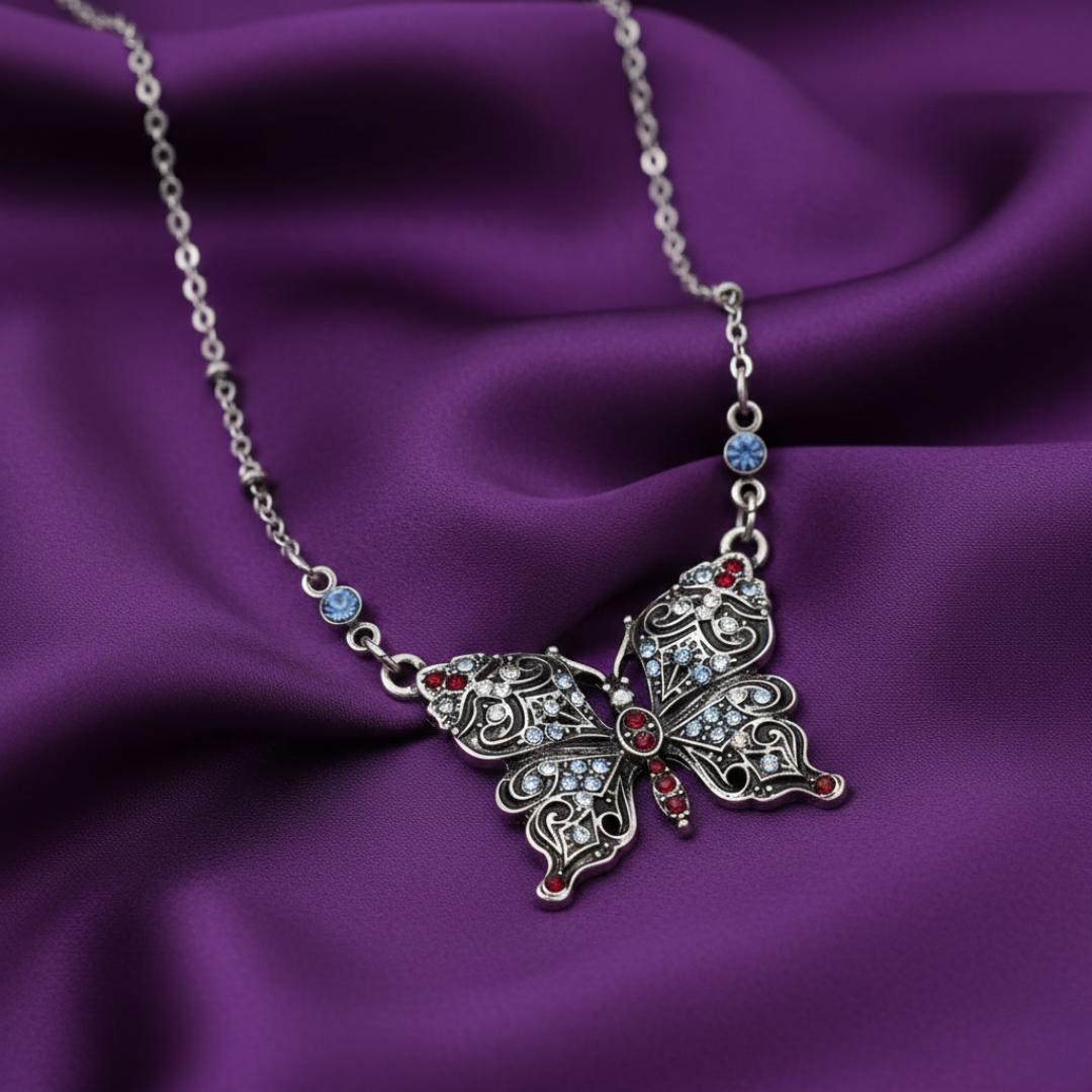 Butterfly pendant necklace on a purple fabric background