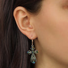 Model wearing our Gold Iridescent AB Crystal & Blue Stone Filigree Cross Leverback Earrings