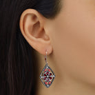 Close up of a woman wearing Diamond Shaped Flower Red Crystal Drop Earrings