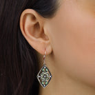 Close up of a woman wearing Diamond Shaped Flower Green Crystal Drop Earring