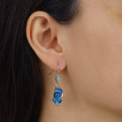 Close up of a woman wearing Blue Blooming Flower Bead & Crystal Drop Earrings
