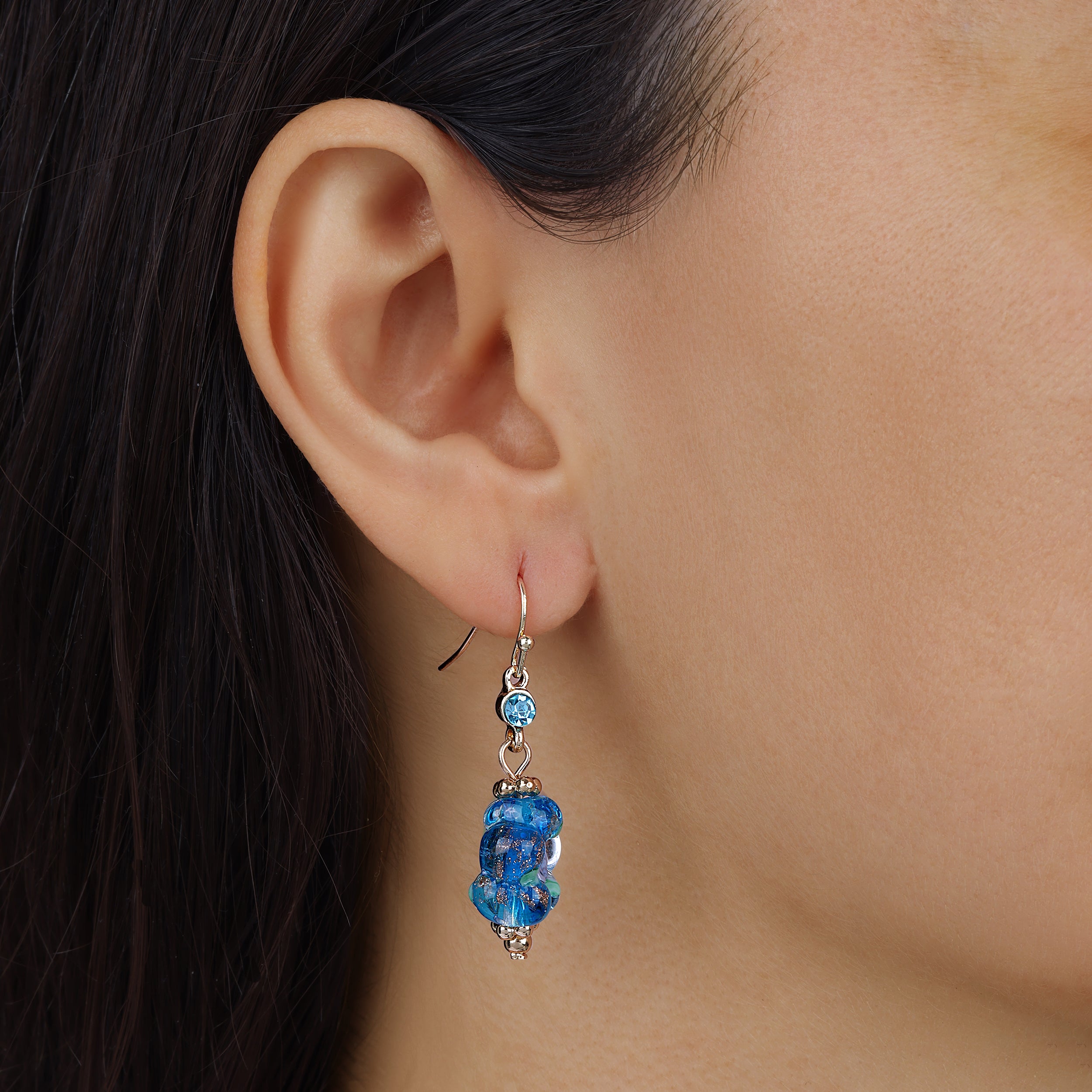 Close up of a woman wearing Blue Blooming Flower Bead & Crystal Drop Earrings