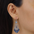Close up of a woman wearing Crescent Blue Briolette Chandelier Earrings