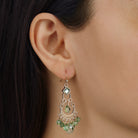 Close up of a woman wearing Crescent Green Briolette Chandelier Earrings