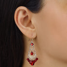 Close up of a woman wearing Crescent Red Briolette Chandelier Earrings