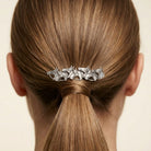 Racing Horses Antiqued Hair Barrette on a person's ponytail against a neutral background