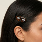 Close-up of a person's hair with a Brown Tortoise Double Heart Horse Head Hair Barrette