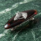 Brown Tortoise Horse Head Hair Barrette on a green marble background
