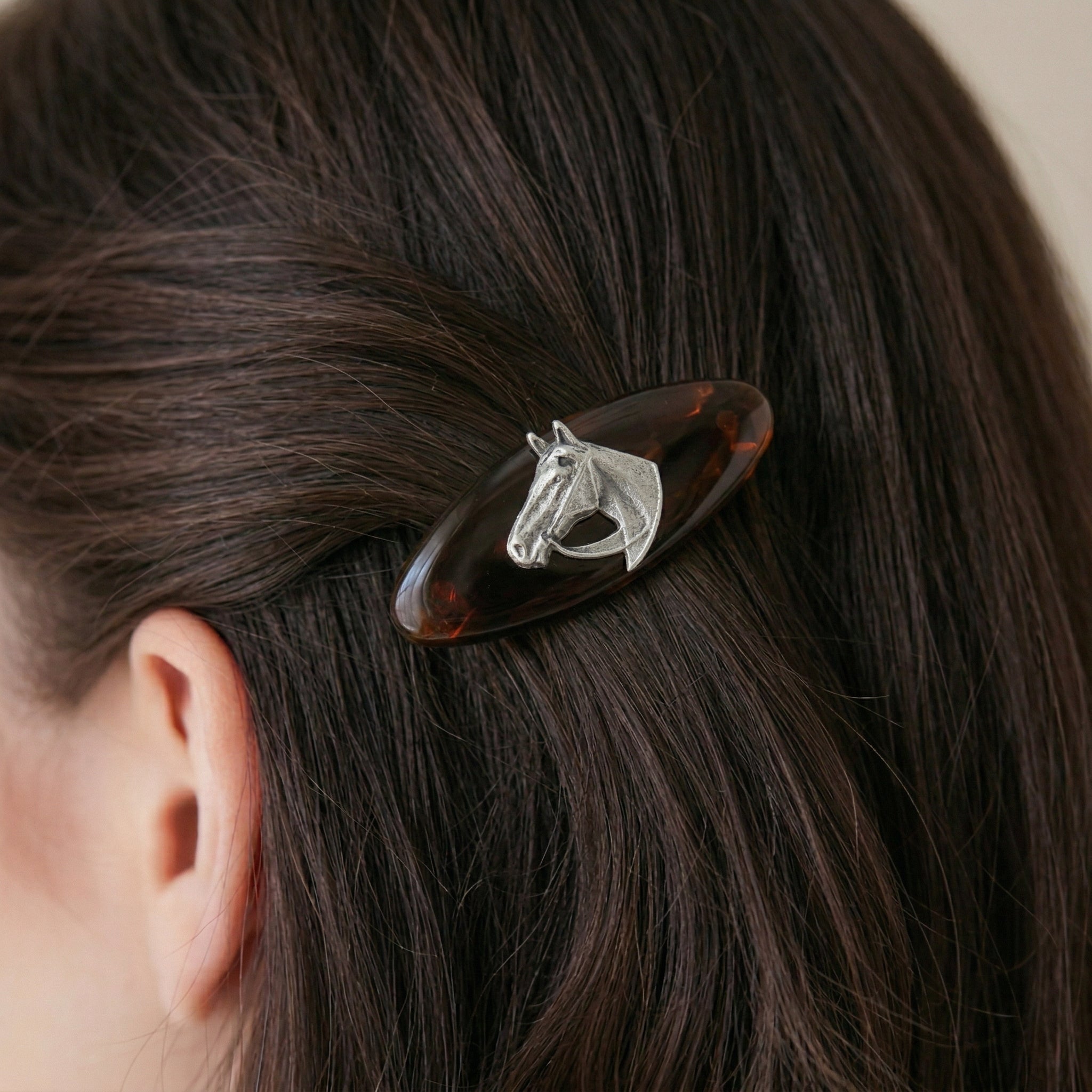 Brown Tortoise Horse Head Hair Barrette on a person's hair