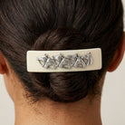 Ivory Racing Horses Hair Barrette on a person's hair against a neutral background
