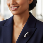 Woman wearing a brooch on her navy blazer.
