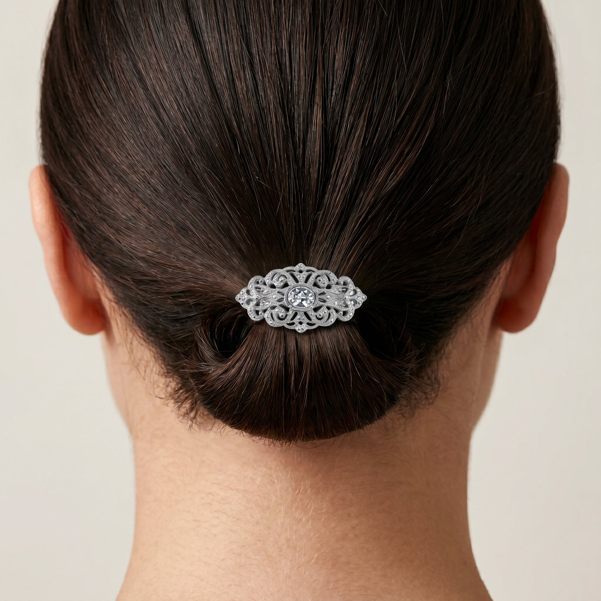 Filigree Austrian Oval Crystal Hair Clip Barrette in a person's hair against a neutral background