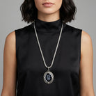 Woman wearing a black sleeveless top with a Black Intaglio Floral Stone Black & Clear Crystal Pendant Necklace