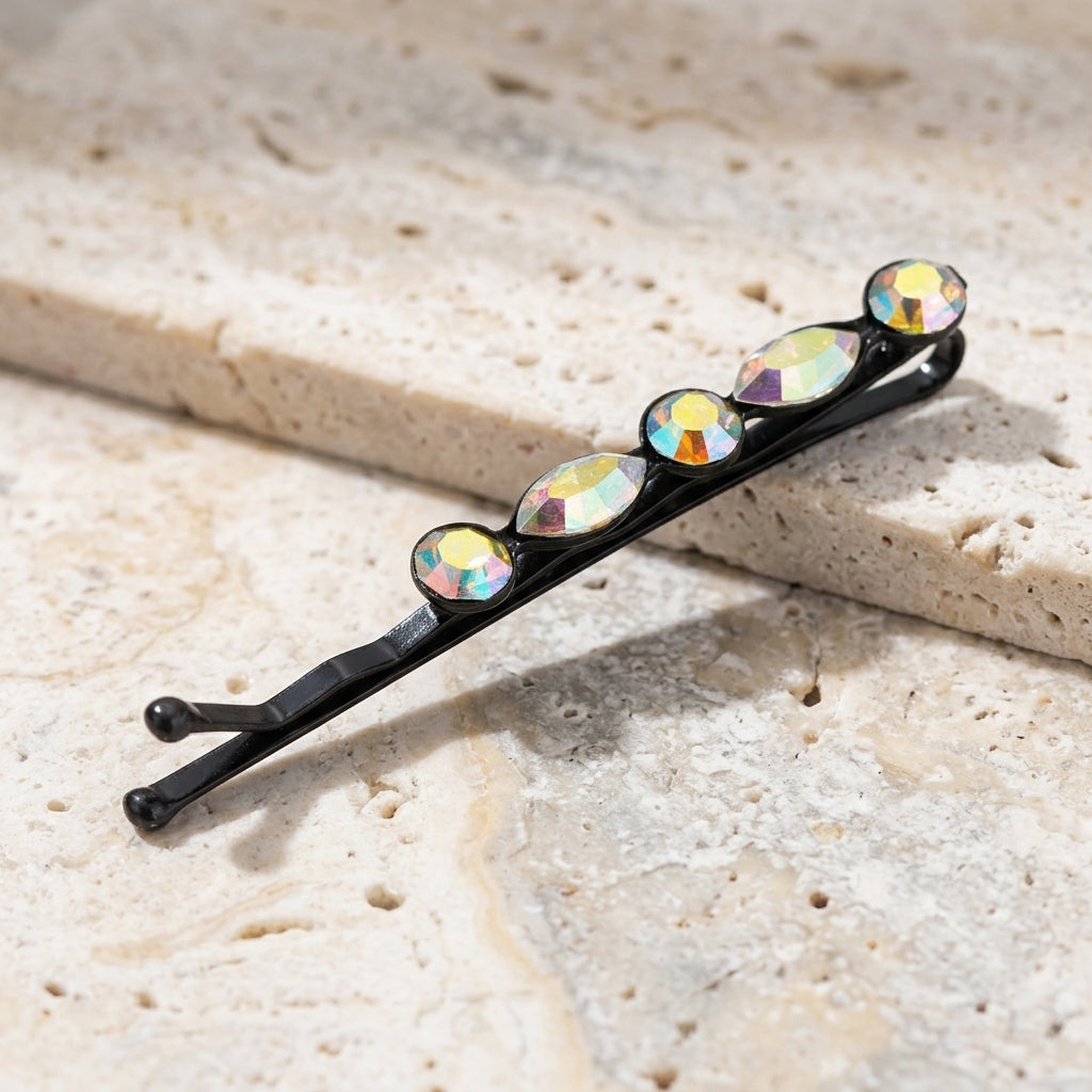 Crystal AB Bobby Pin on a textured beige stone surface