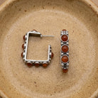 Pewter Genuine Sandstone Square Earrings displayed on a textured beige ceramic dish.