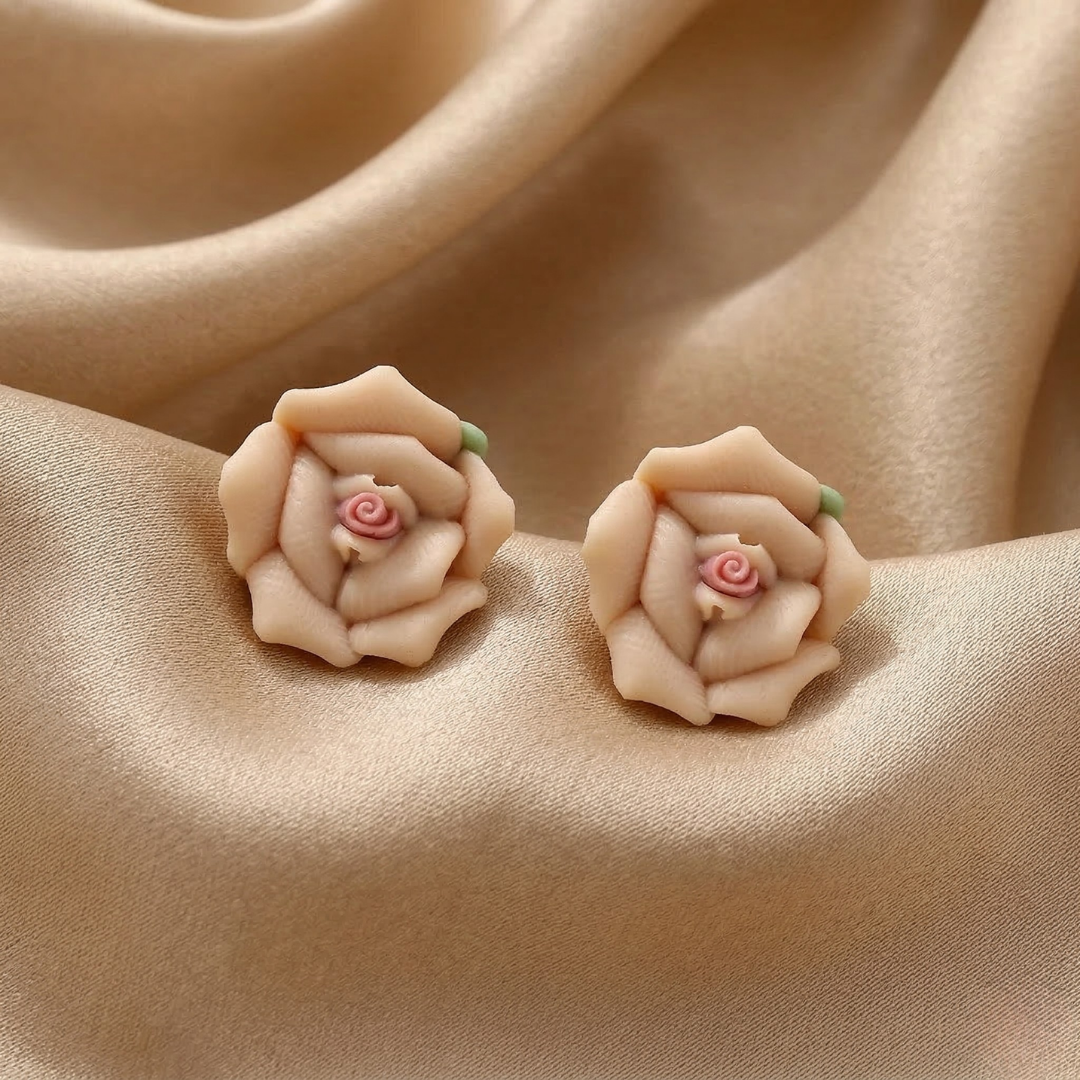 Pair of floral earrings on beige fabric
