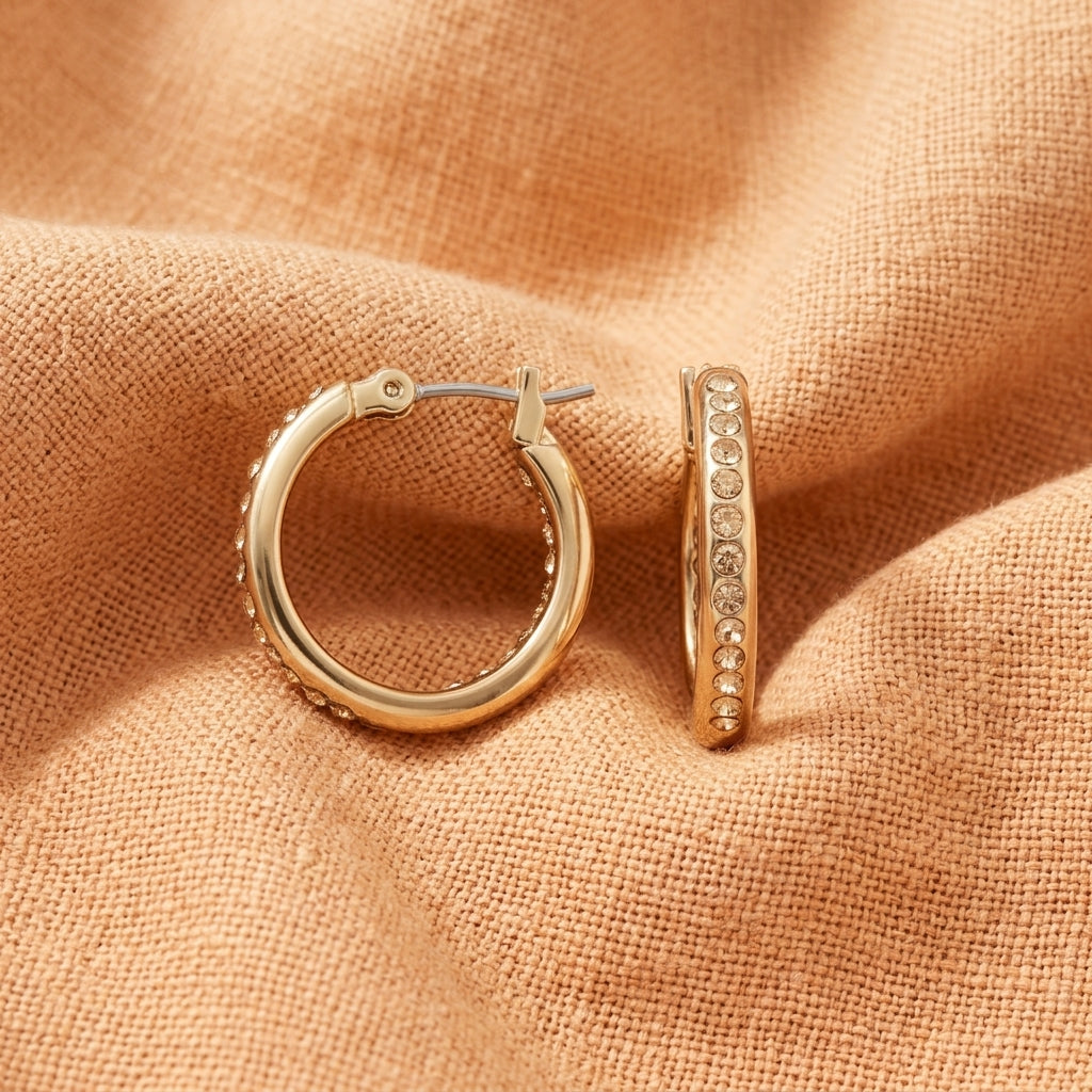 Topaz Wedding Band Hoop Earrings displayed on a textured, peach-colored fabric background.