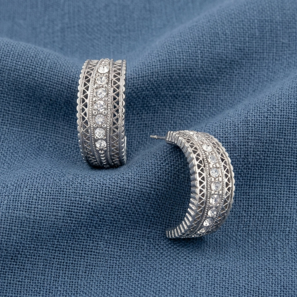 Crystal Hoop Earrings displayed on a textured blue fabric background.