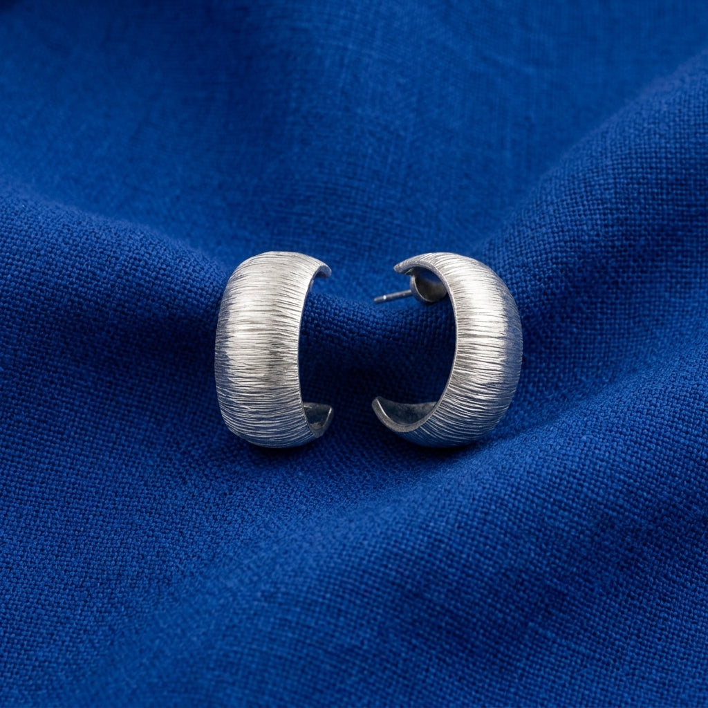 Silver Hoop Brushed Finish Earrings on cobalt blue colored linen fabric