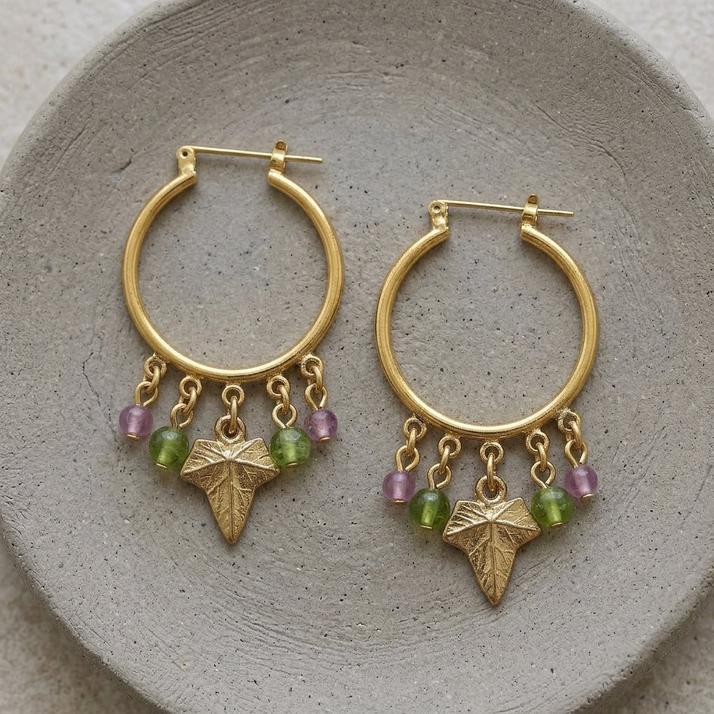 Winery Multi-Color Beaded Grape Leaf Snap In Hoop Earrings on a gray ceramic clay plate
