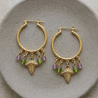 Winery Multi-Color Beaded Grape Leaf Snap In Hoop Earrings on a gray ceramic clay plate