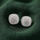Square Pave Crystal Button Earrings resting on dark green linen