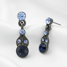 Pair of earrings with blue gemstones on a white background