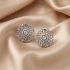 Crystal Filigree Large Button Earrings resting on champagne satin fabric