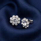 Crystal Flower Stud Earrings resting on navy blue fabric