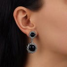 Close up of a woman's ear wearing our Black Cabochon Drop Earrings