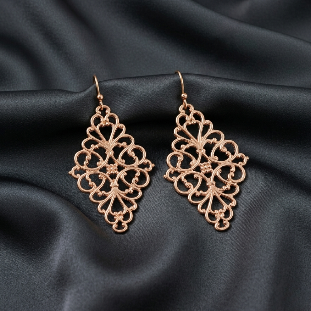 Decorative earrings on a black satin background