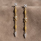 Antiquities Couture Two Tone Crystal Linear Drop Earrings on warm brown suede