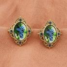 Winery Purple Grapes Decal Post Earrings displayed on a peach fabric background.
