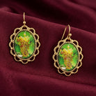 Winery Yellow Grapes Decal Oval Drop Earrings displayed on a draped burgundy fabric background.