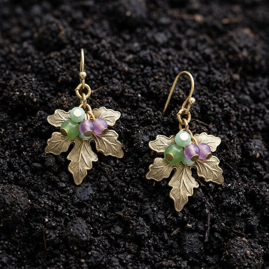 Winery Grape Leaf Multi-Color Bead Accents Drop Earrings resting on dark soil