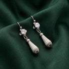 Drop Earrings Made With Austrian Crystal rests on dark green satin fabric