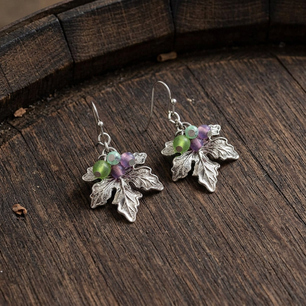 Winery Grape Leaf Multi-Color Bead Accents Drop Earrings on a dark wooden barrel surface