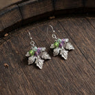 Winery Grape Leaf Multi-Color Bead Accents Drop Earrings on a dark wooden barrel surface