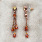Light Colorado Topaz Tassel Earrings resting on light colored linen