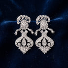 Antiquities Couture St. James Eternity Club Pave Crystal Drop Earrings displayed on dark navy blue velvet