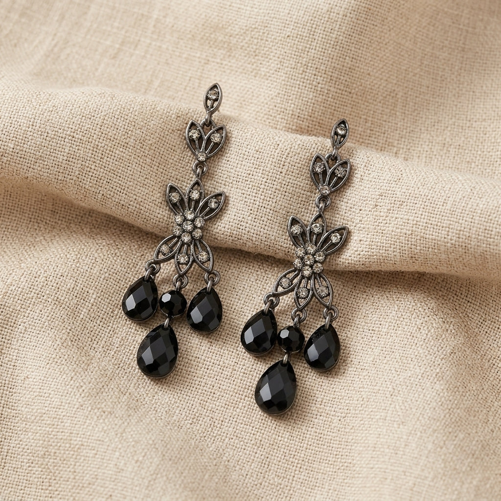 Triple Black Diamond Teardrop Crystal Post Dangle Earrings resting on beige linen