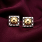 Fusion Lux Square Stud Earrings resting on burgundy satin fabric