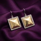 Fusion Lux Large Square Earrings resting on dark purple satin fabric
