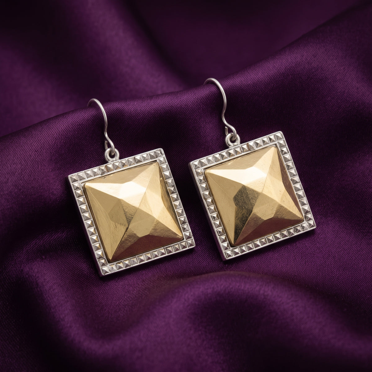 Fusion Lux Large Square Earrings resting on dark purple satin fabric