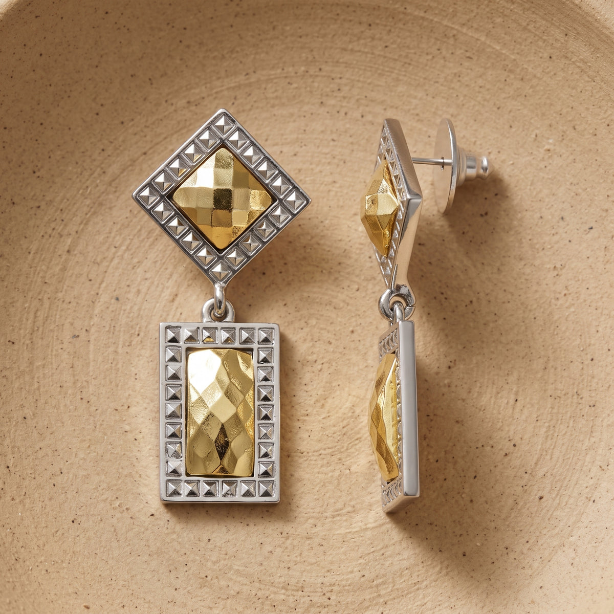 Fusion Lux Double Drop Square Earrings on a clay pottery surface