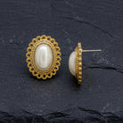Faux Pearl Oval Button Earrings on a dark stone surface