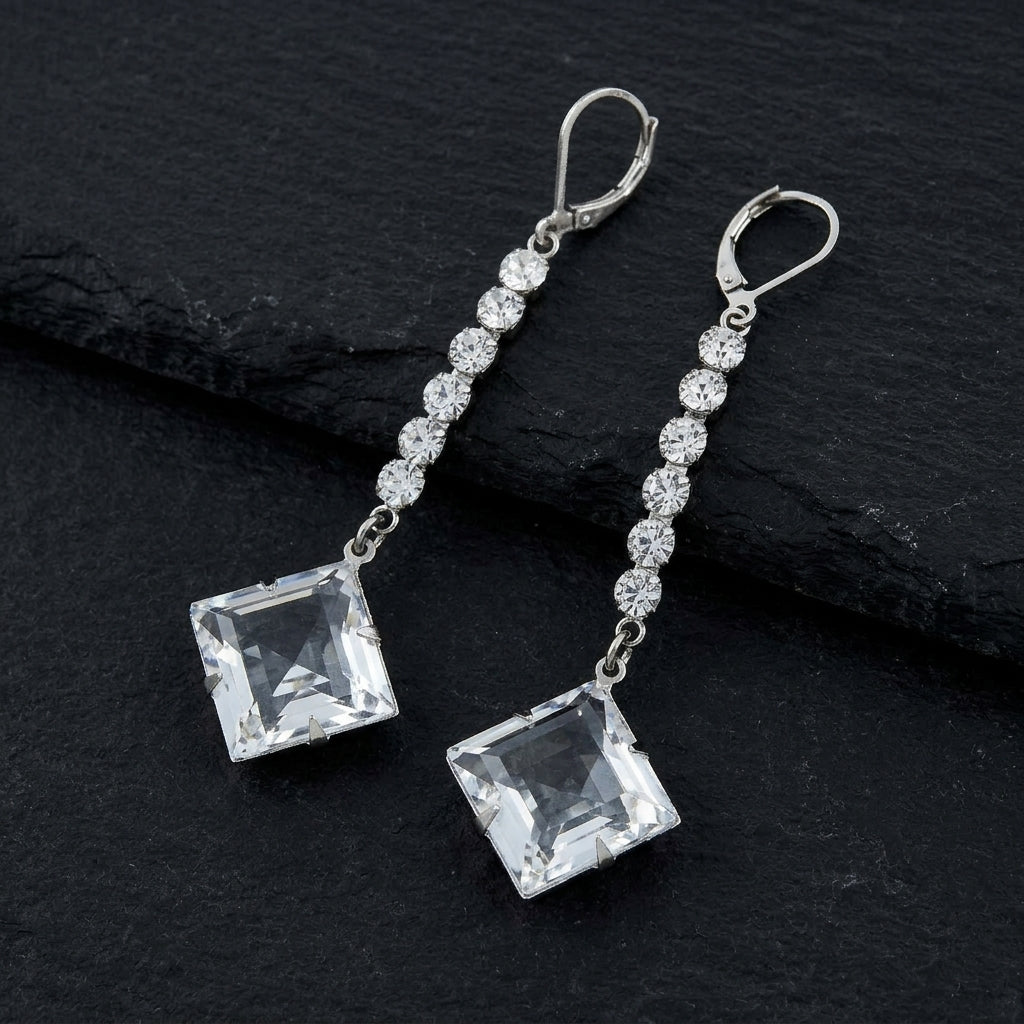 Genuine Austrian Crystal Diamond Shape Drop Linear Earrings on black stone surface