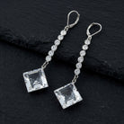 Genuine Austrian Crystal Diamond Shape Drop Linear Earrings on black stone surface