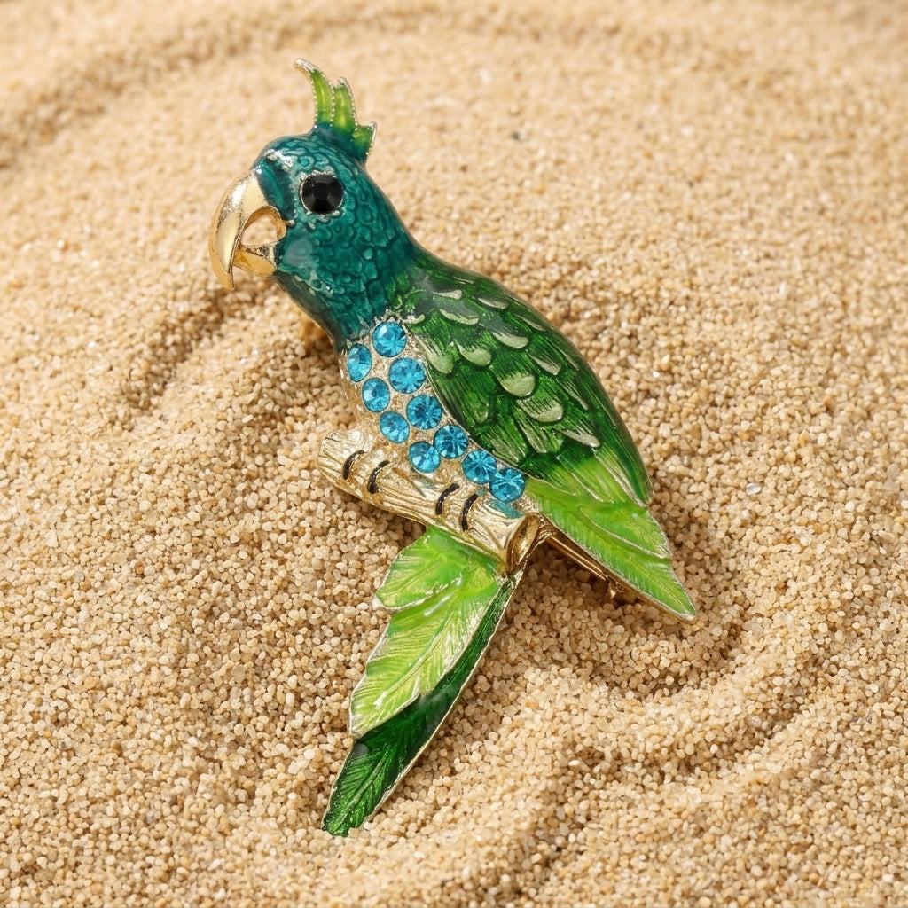 Neotropic Enamel & Crystal Perched Parrot Pin resting on sand